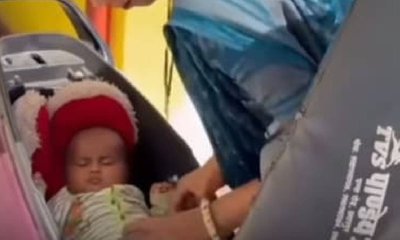 ಡಿಕ್ಕಿಯೊಳಗೆ ಮಗುವನ್ನು ಮಲಗಿಸಿ ಸ್ಕೂಟರ್ ಚಲಾಯಿಸಿದ ಮಹಿಳೆ